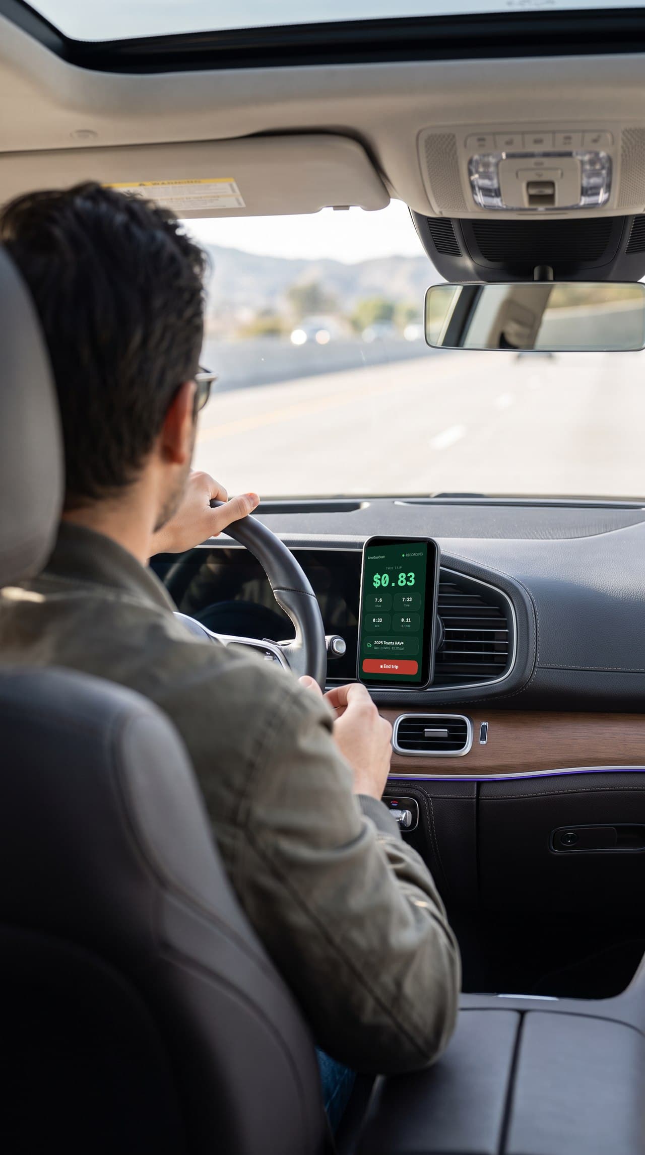 LiveGasCost running on a phone mounted to the dashboard while driving